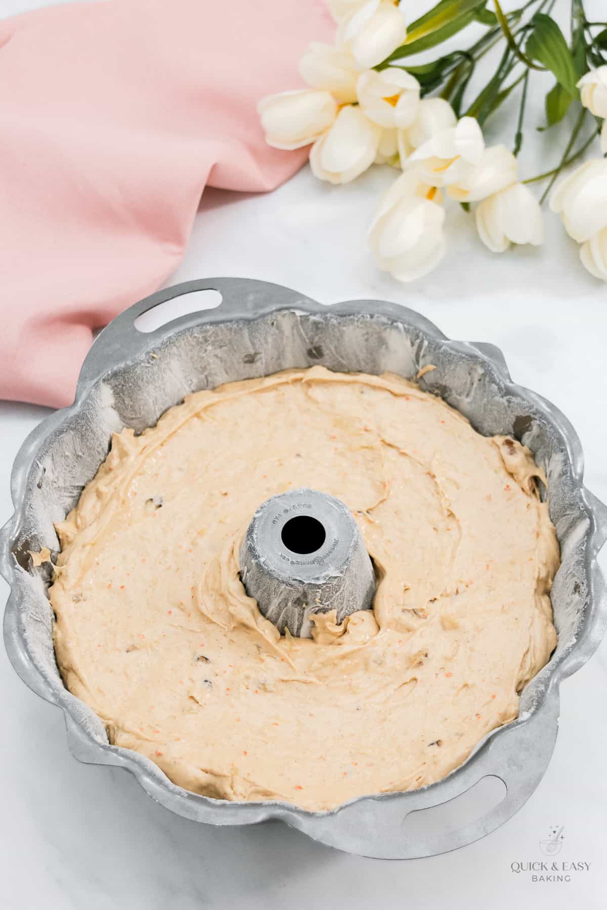 Smooth cake batter in a bundt pan.