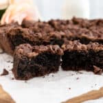 Cut cake mix brownies on a wooden board.
