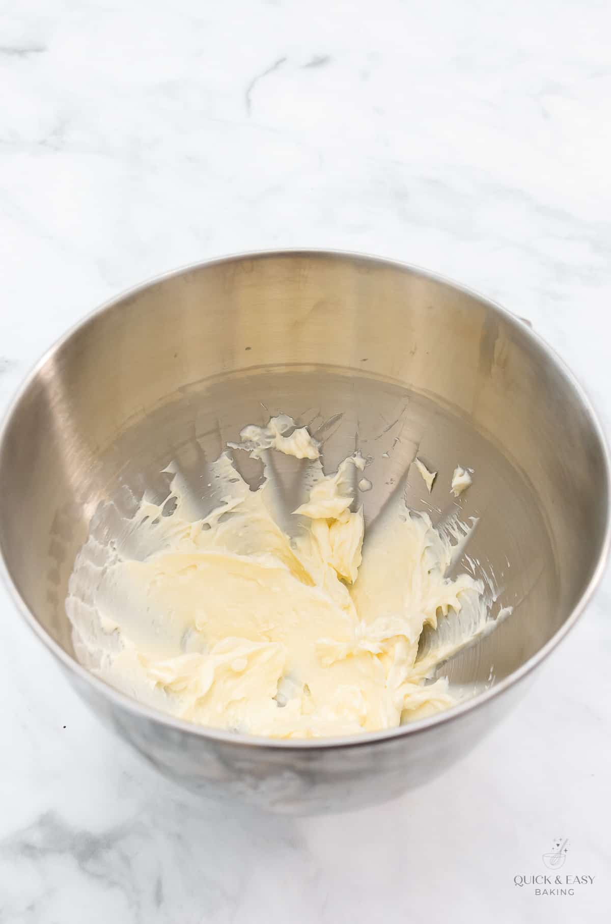 Mixing butter and cream cheese in mixing bowl.