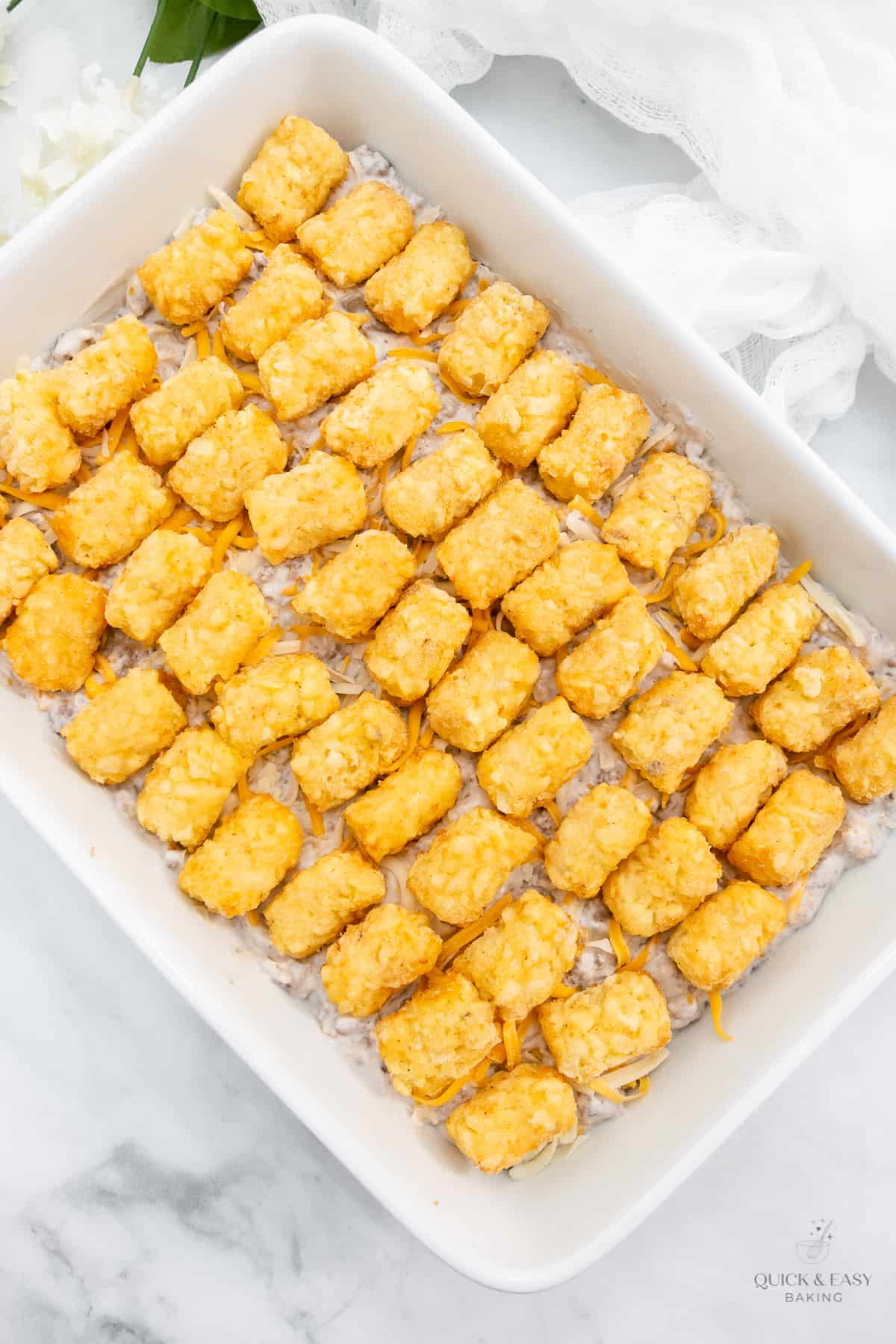 Add tater tots to casserole.