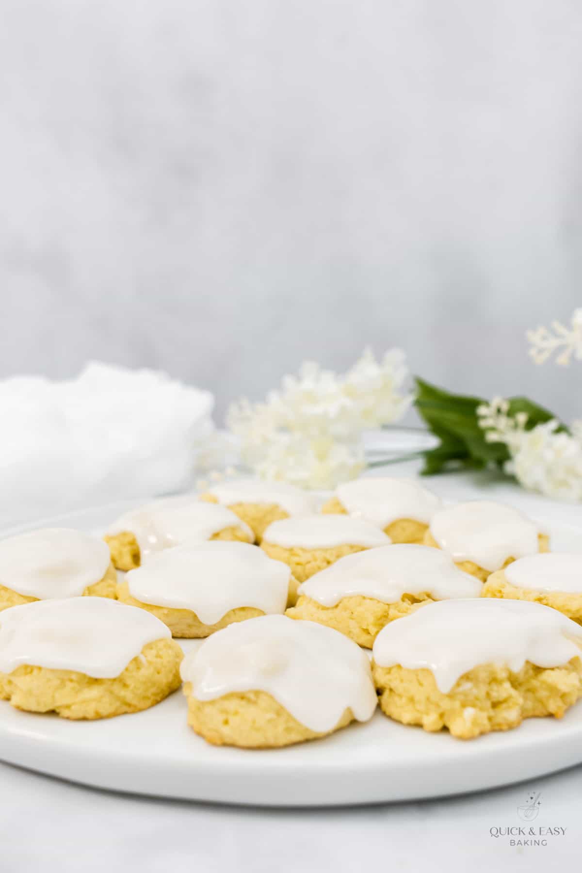 Lemon cookies on a white plate with glaze.