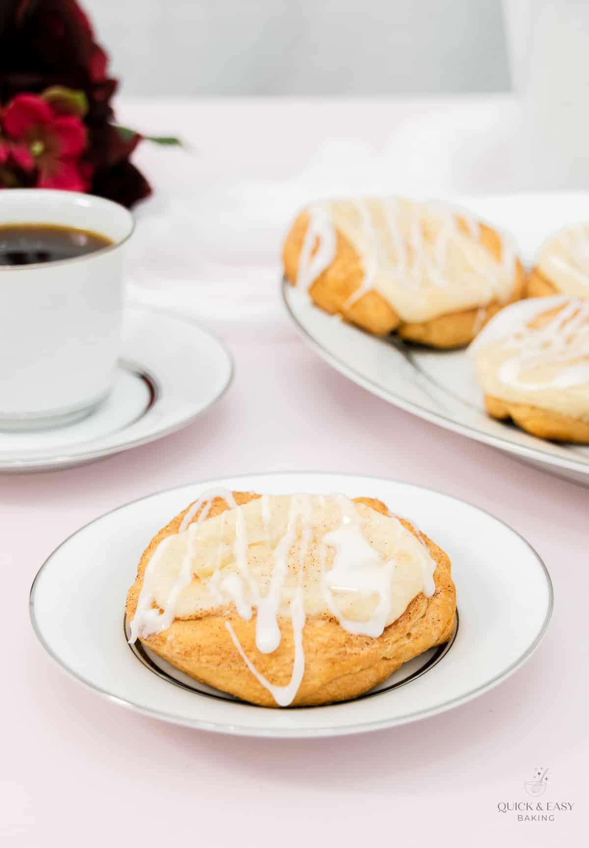 Cream cheese danish on a plate with coffee.