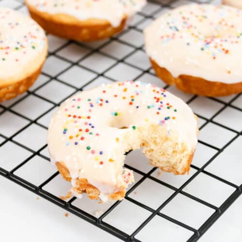 Close view of vanilla baked donuts with sprinkles.