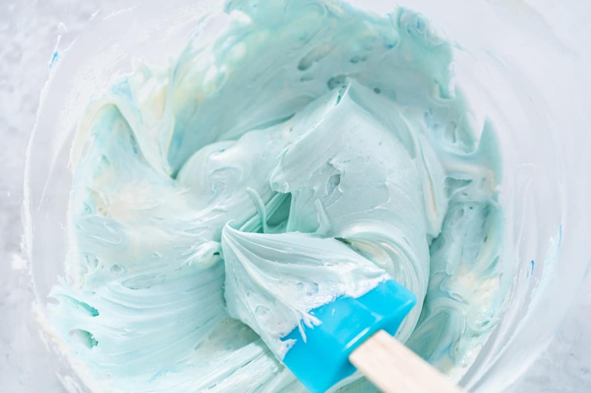 Blue icing in a glass bowl.