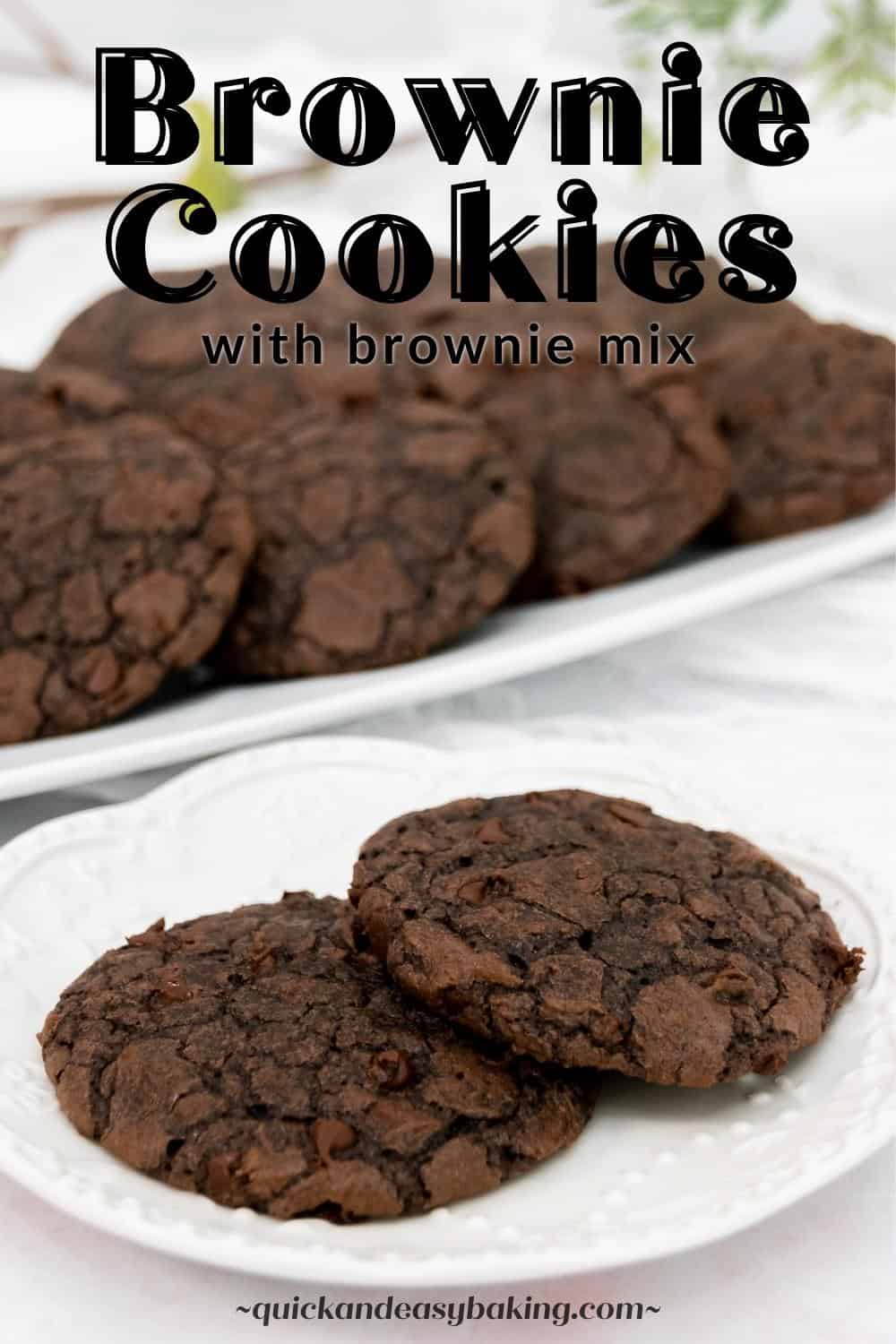 Two chocolate cookies on a white plate with a tray of cookies and text overlay.