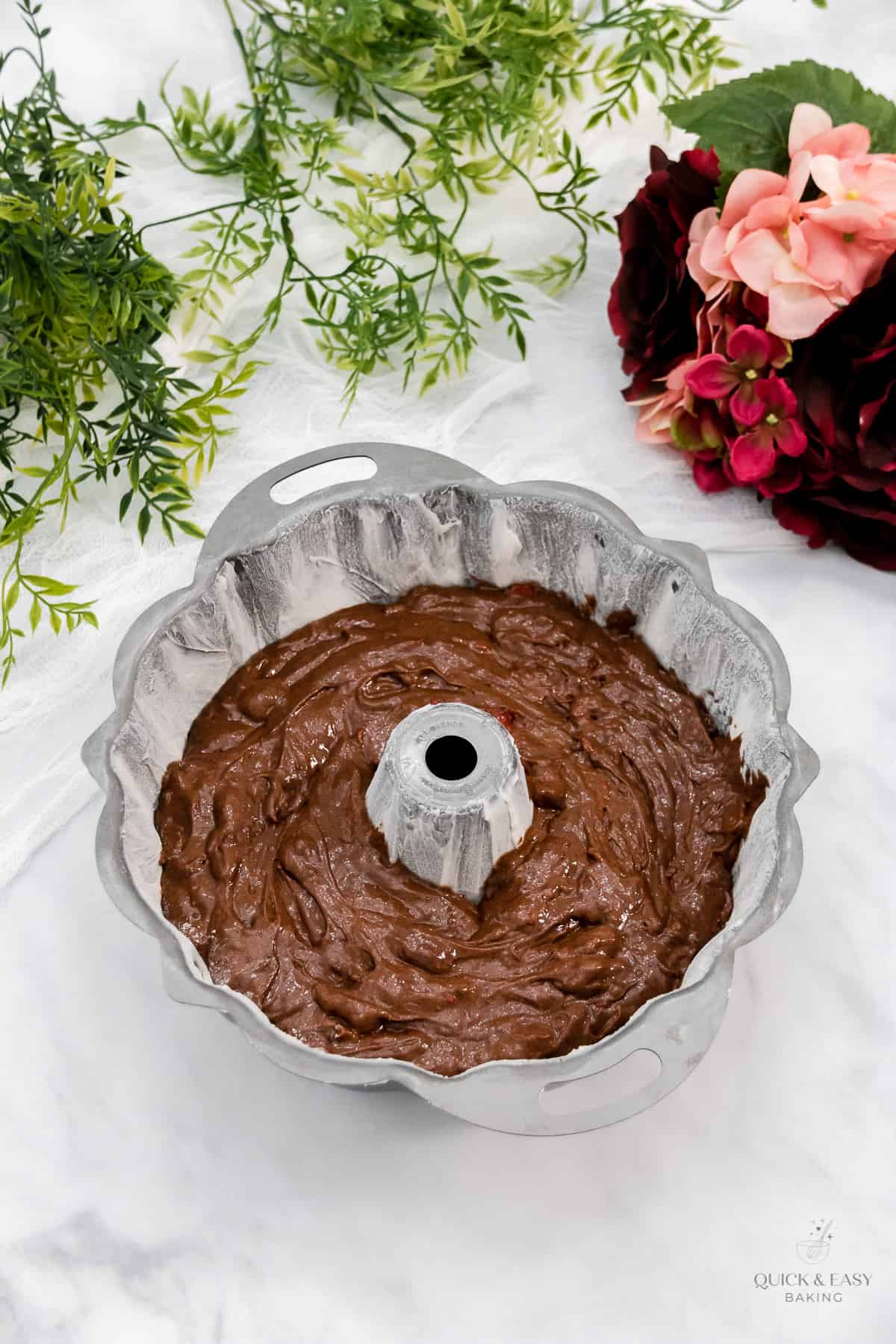 Chocolate Cherry cake batter smoothed into a bundt pan.
