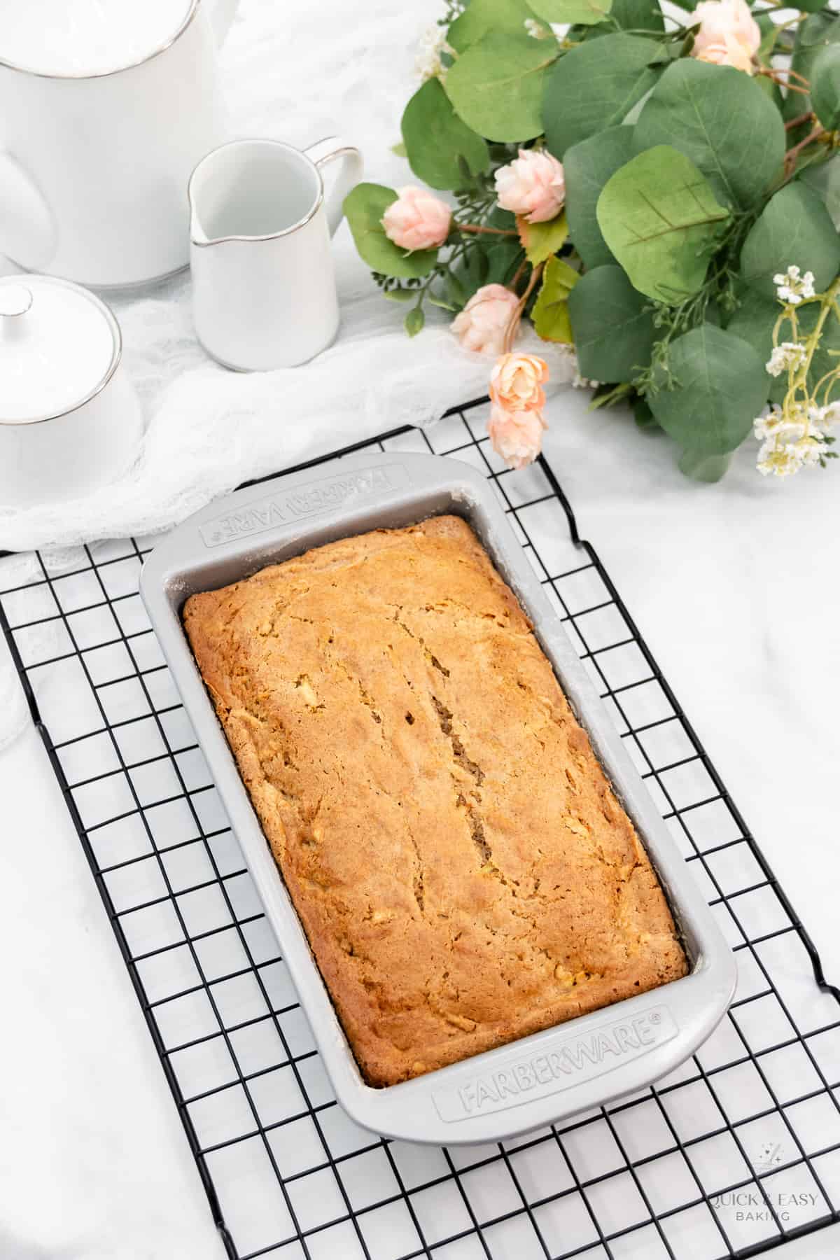 Baked sweet quick bread in a pan on a rack.