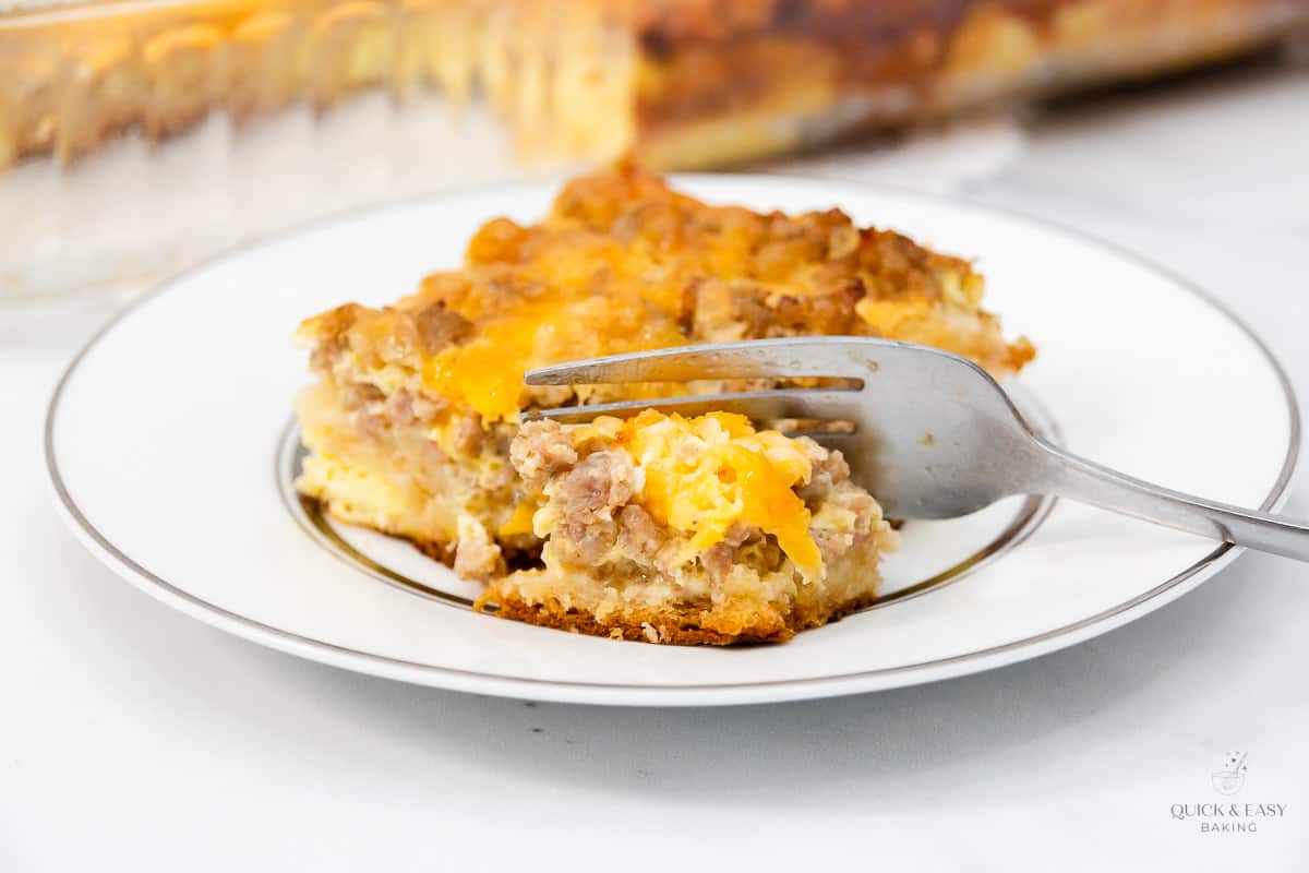 Close up view of egg bake with a fork on a white plate.