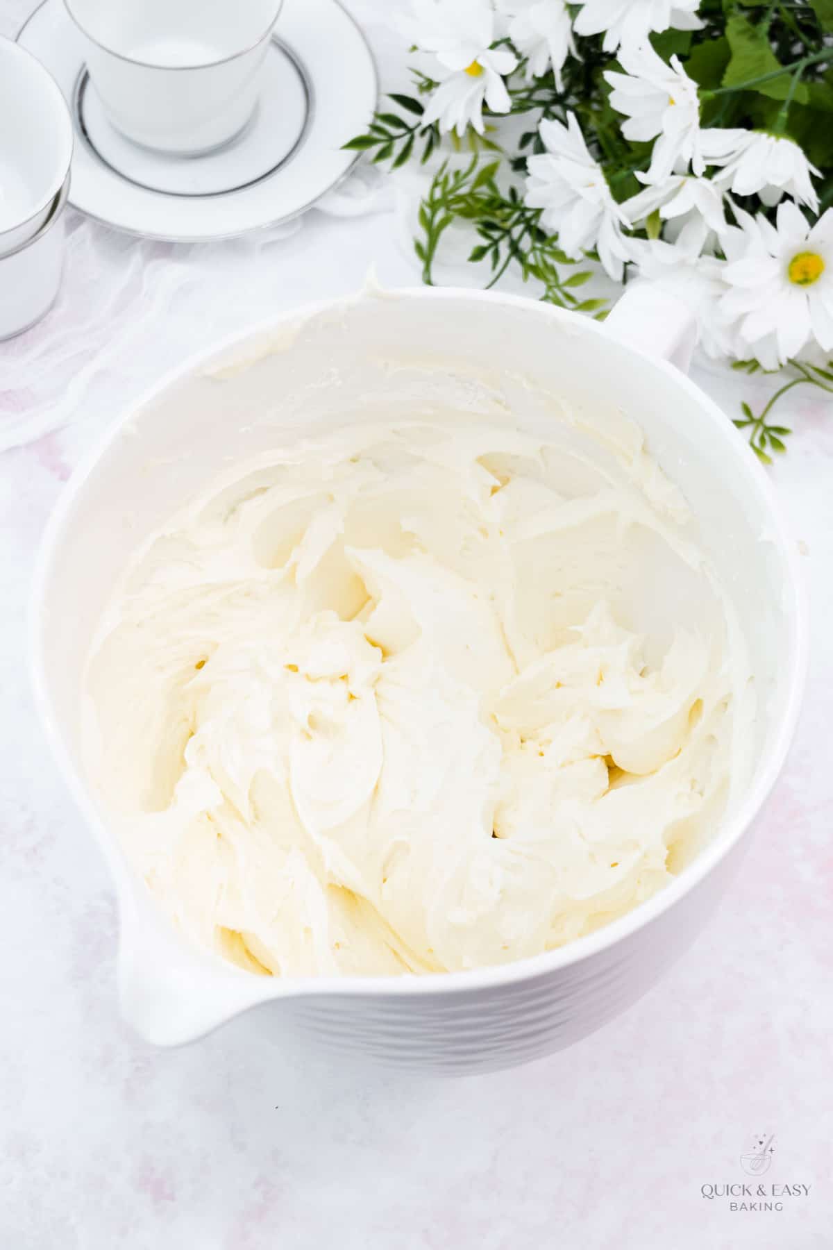 Fluffy cream cheese buttercream in a white bowl.