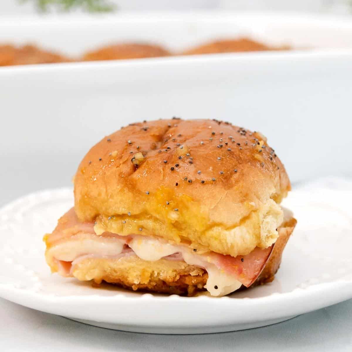 Featured image of baked sliders with cheese and deli meat.