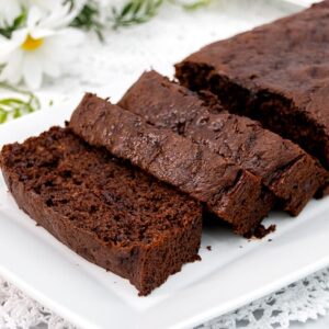 Featured image of chocolate banana bread on a white platter.