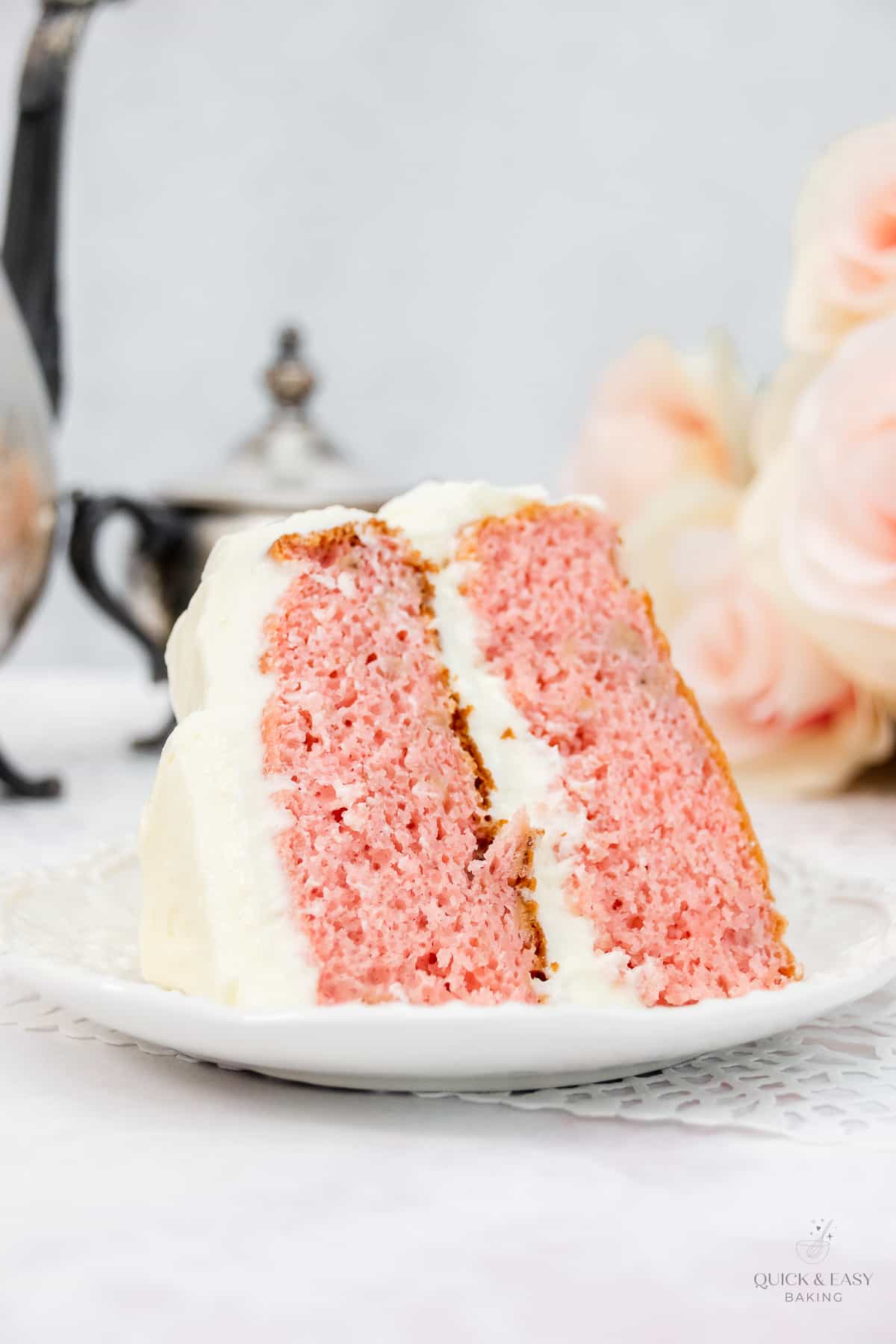 Large slice of strawberry banana cake on a white plate.