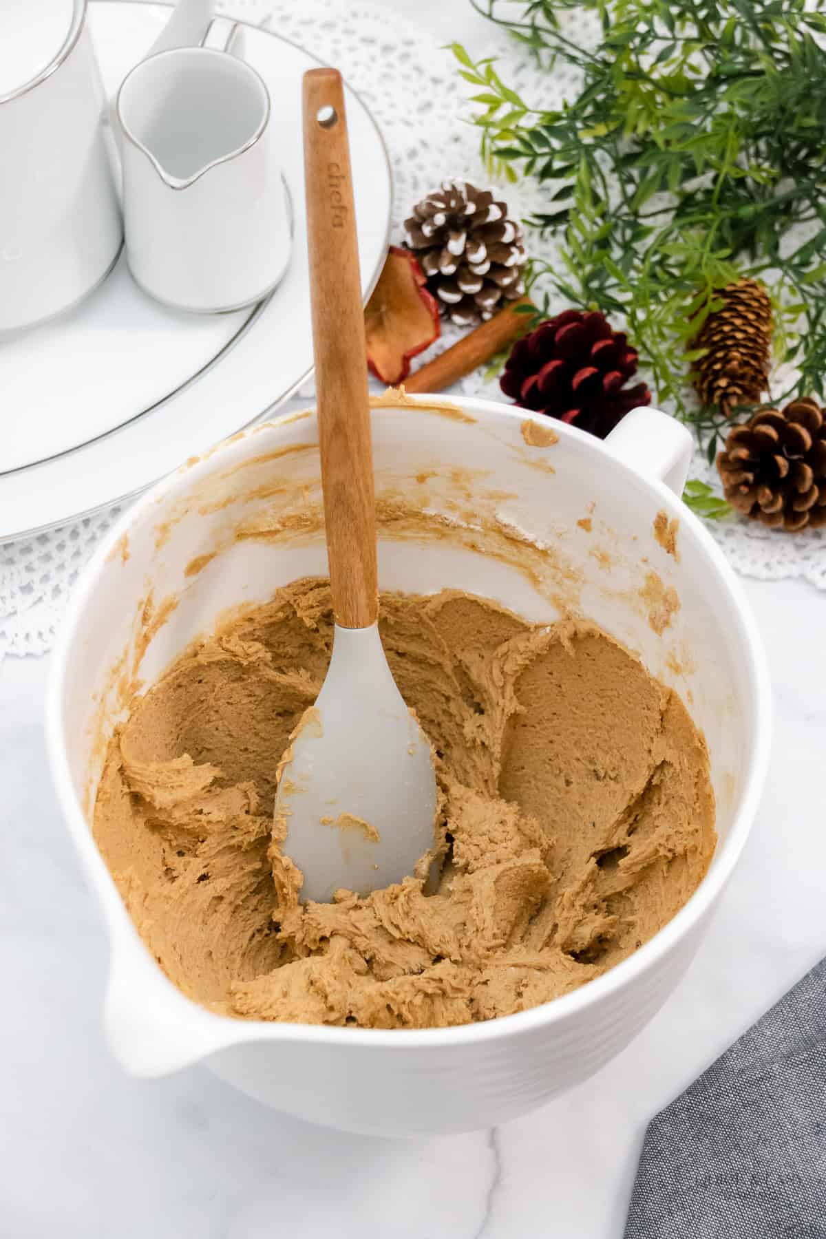 Gingerbread cookie dough in a white bowl.