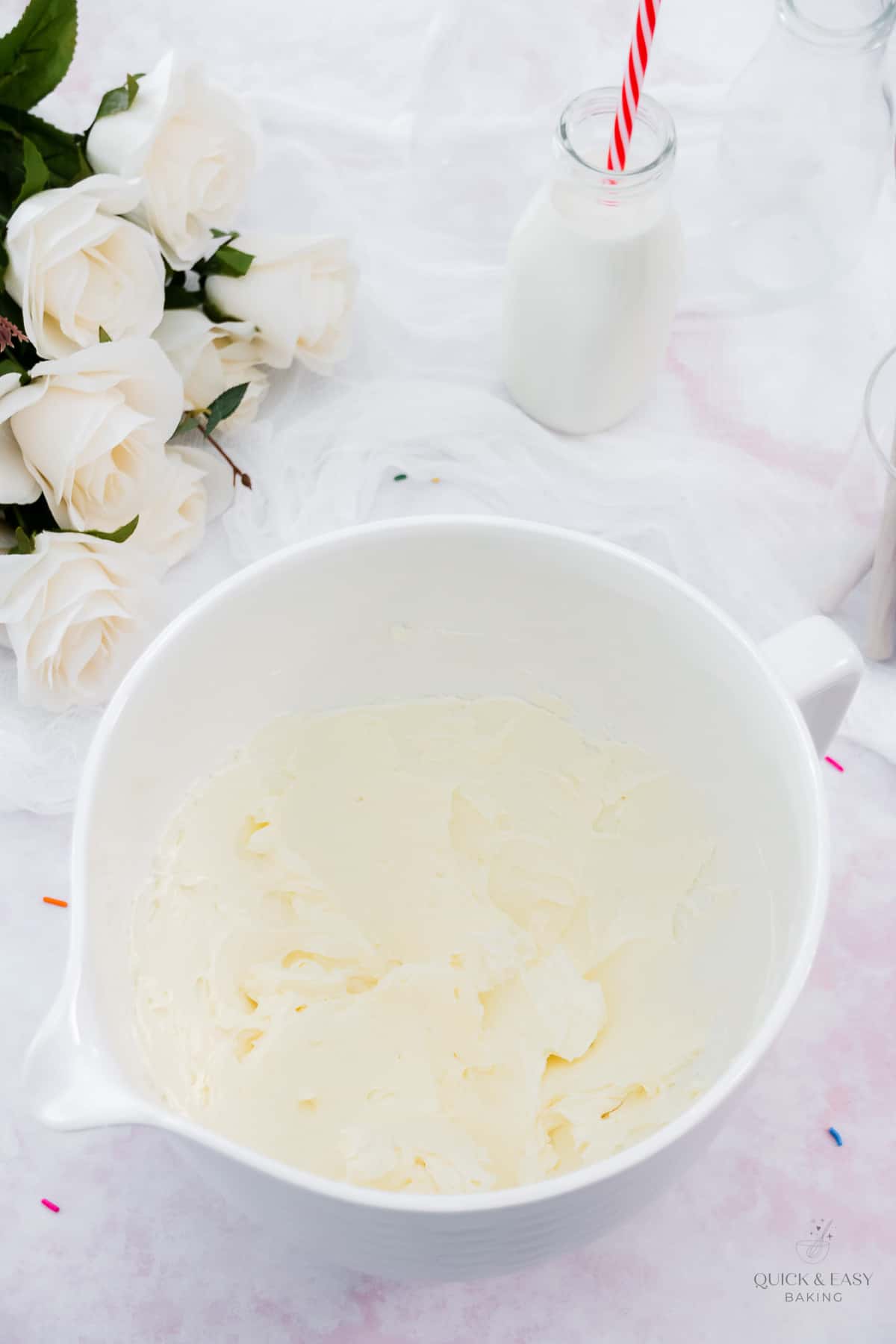 Cheesecake batter in a white mixing bowl.