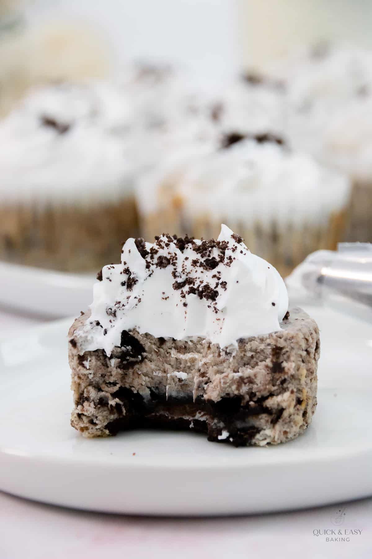 Clsoe up of mini oreo cheesecake with a bite taken out.