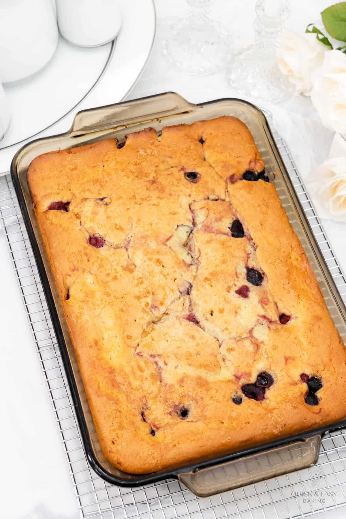 Baked cake with berries in a baking pan.