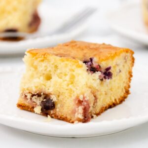 Featured image with close up of vanilla cake and frozen berries.