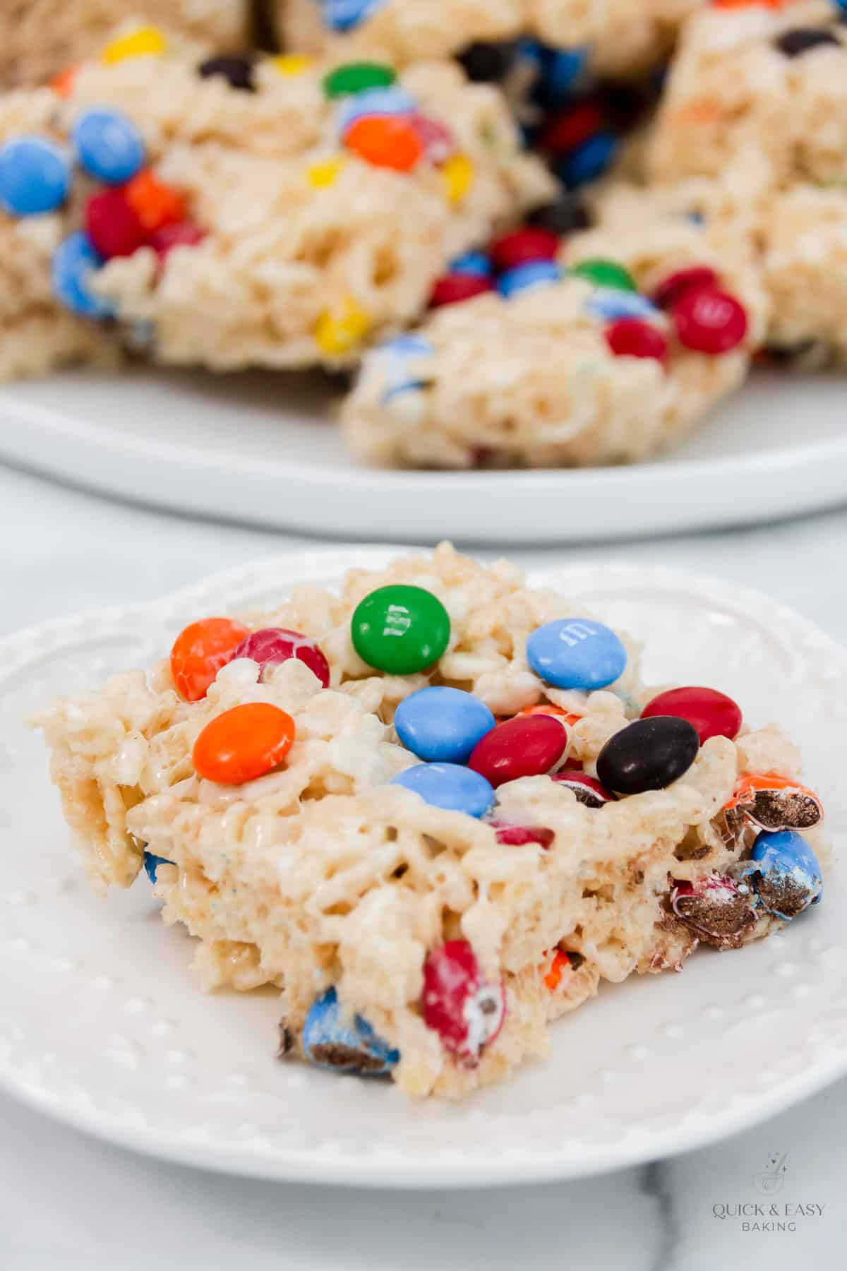 Top down close up of rice crispy treat on a plate with m&ms.