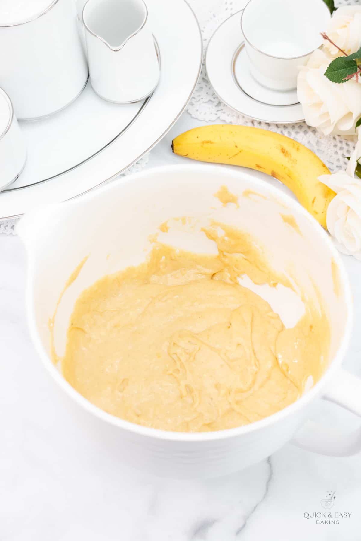 Banana muffin batter in a large white mixing bowl.