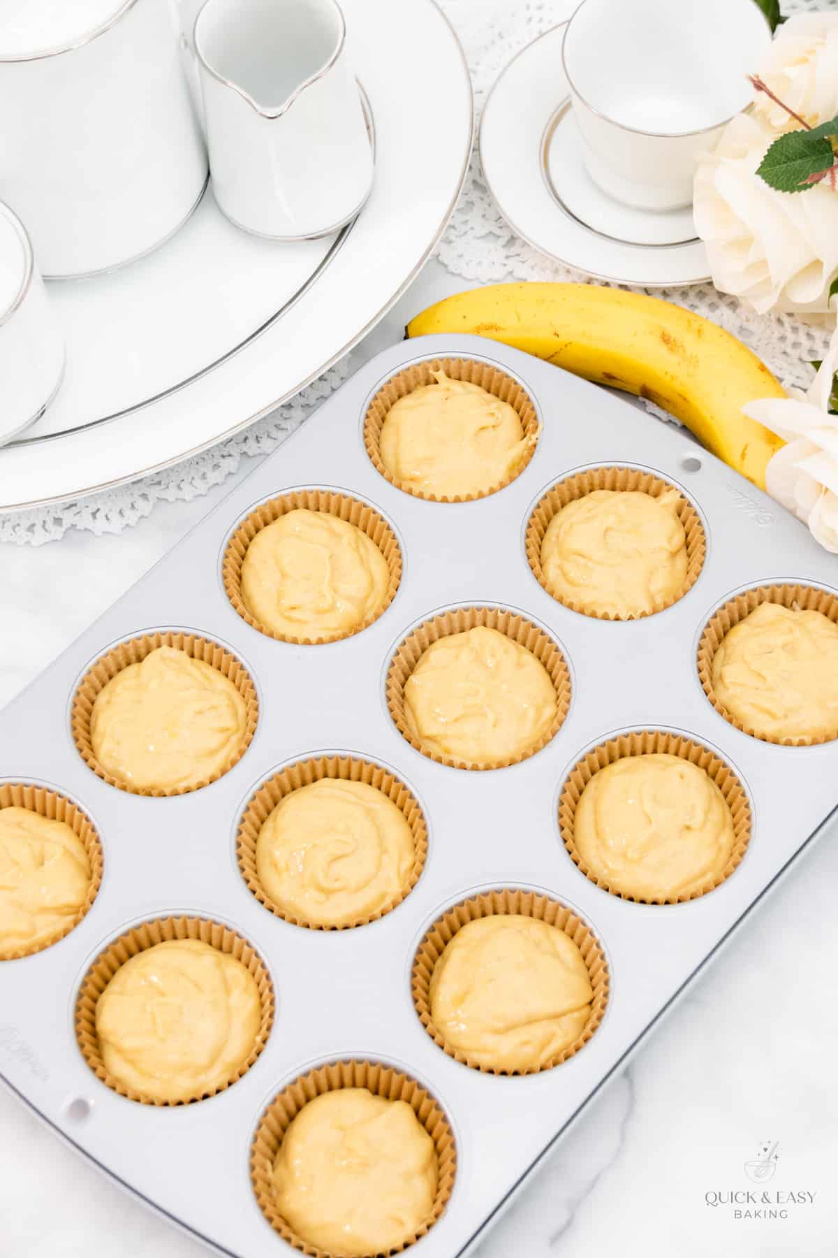 Muffin batter with bananas in cupcake liners.