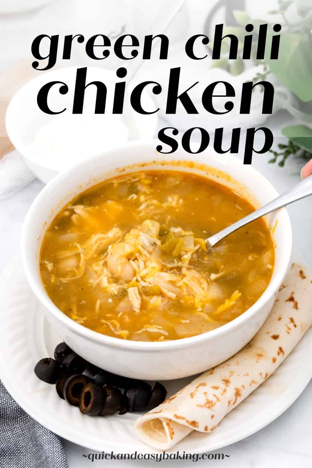 View of green chili chicken soup pinterest image with text overlay and blow of soup with a spoon.