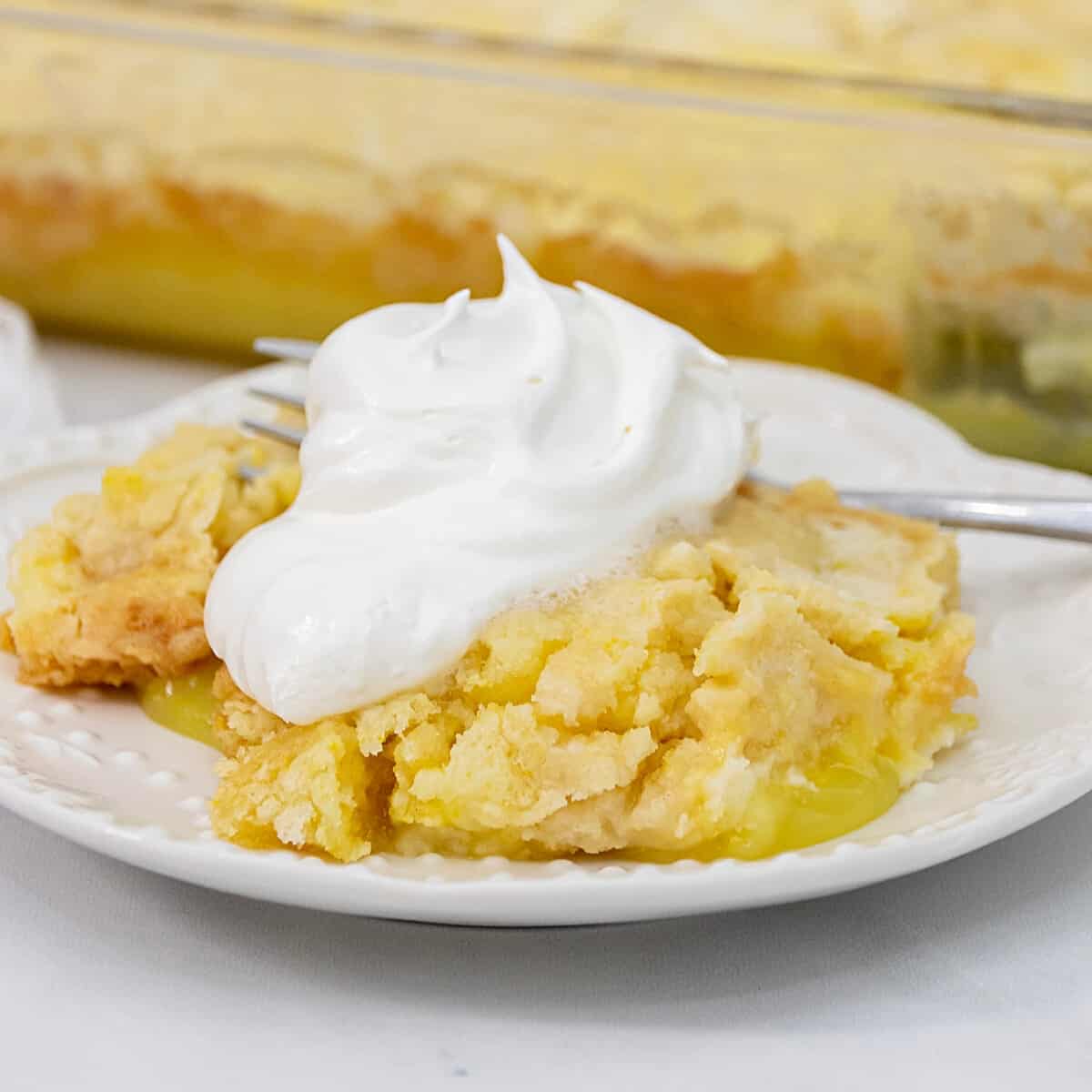Featured image of lemon cake with cake mix and lemon filling with whipped cream.