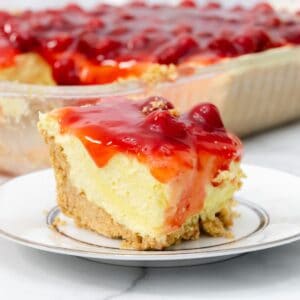 Featured image of no bake cherry cheesecake on a white plate.