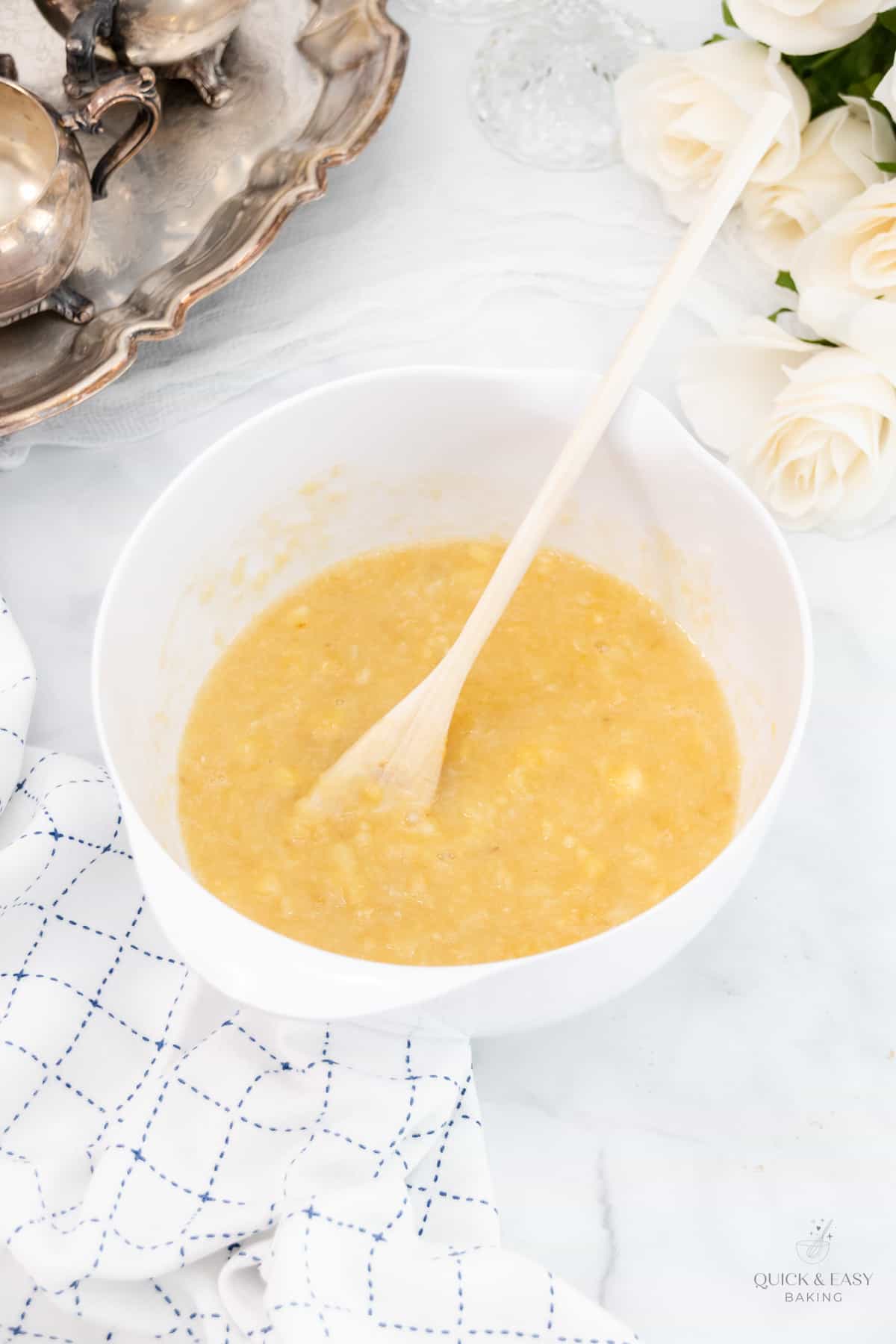 Banana bread batter in a white bowl.