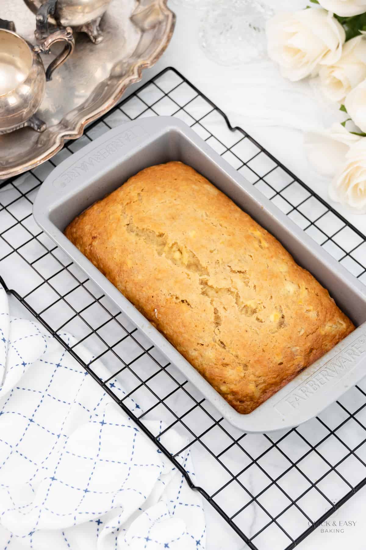 Baked pineapple bread with bananas in a pan.