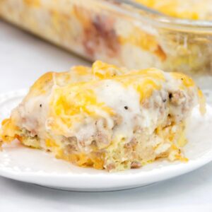 Featured image of biscuits and gravy breakfast casserole on a white plate.
