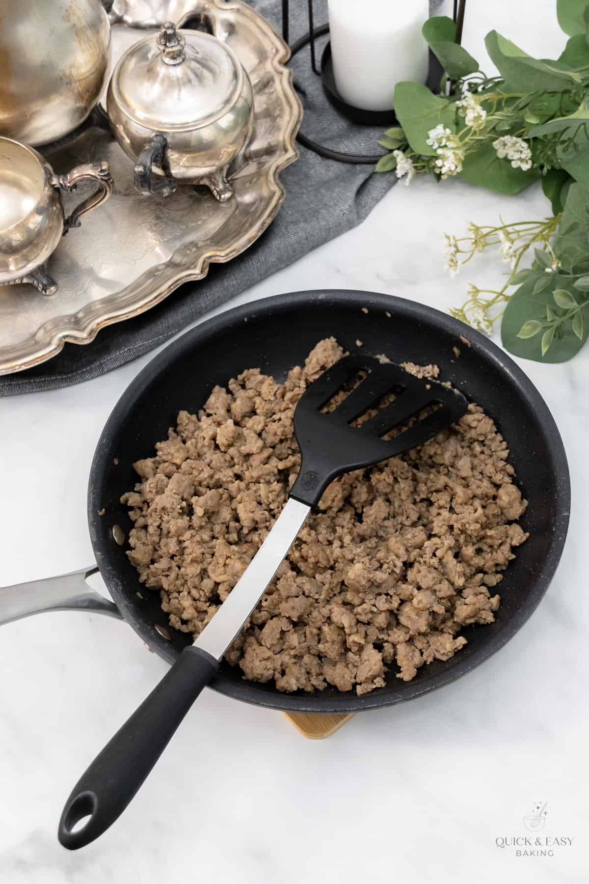 Breakfast sausage cooked into a skillet.