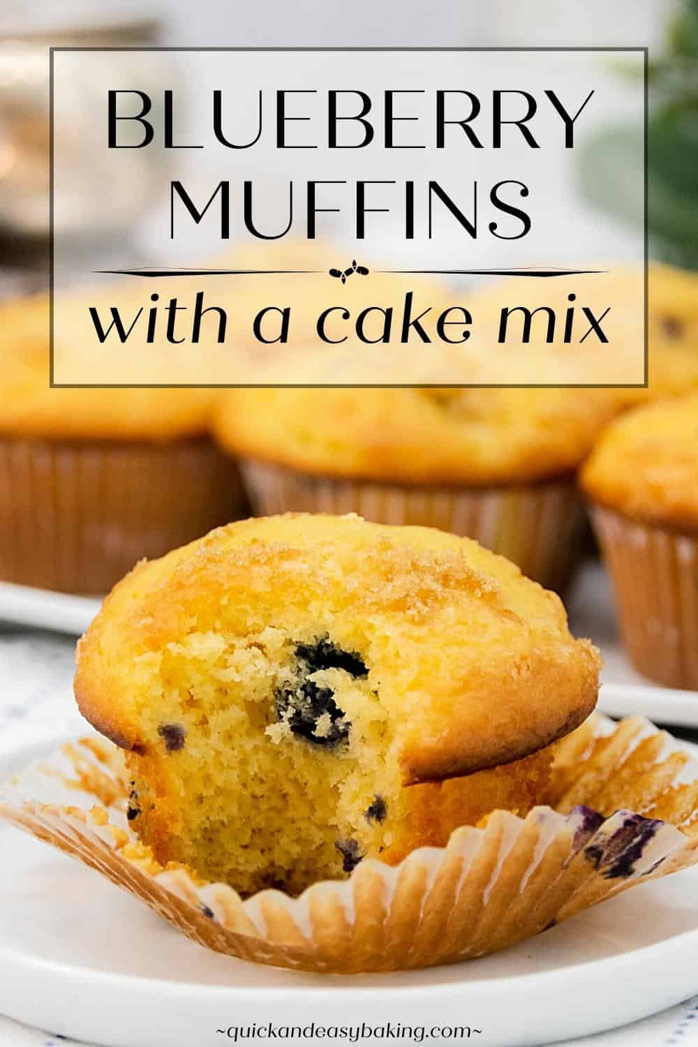 Baked muffin with a bite out of it unwrapped on a white plate with text overlay.