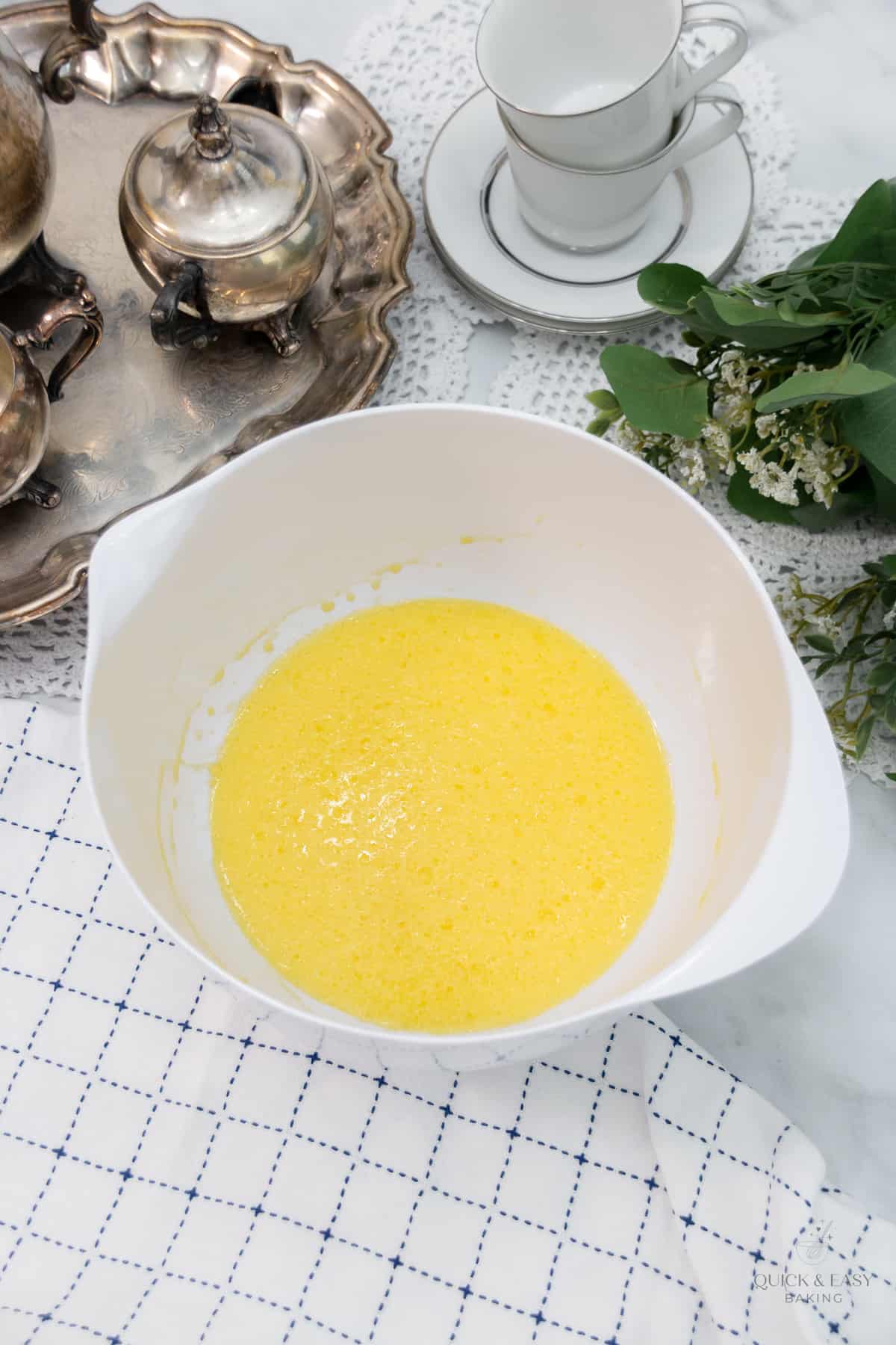 Liquid muffin batter in a white mixing bowl.