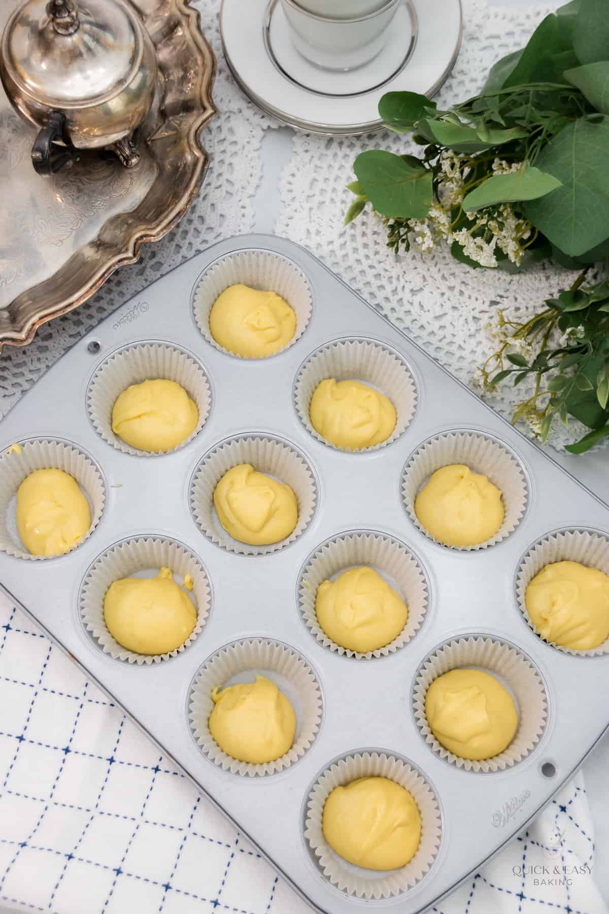 Cupcake liners filled halfway with plain muffin batter.