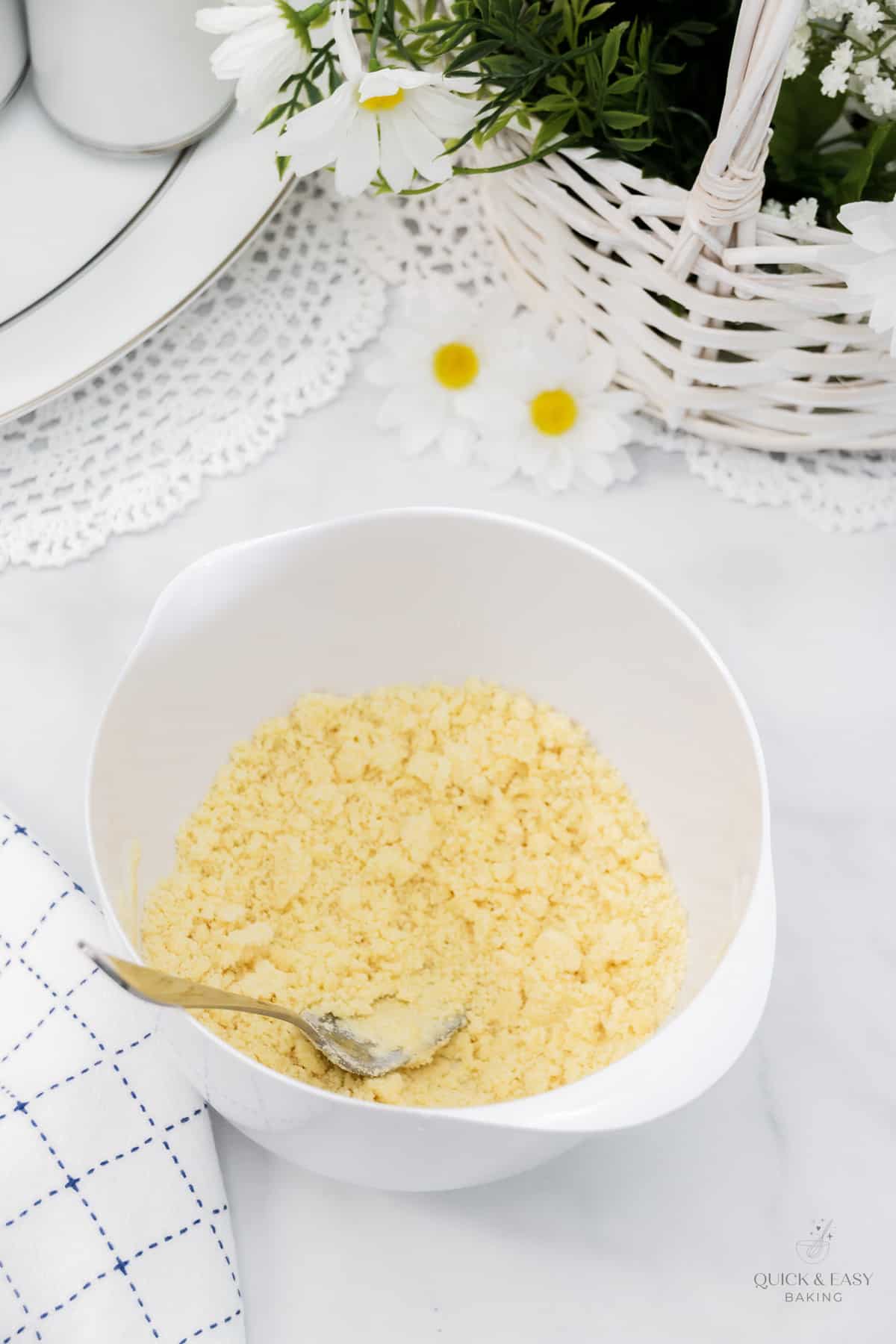 Lemon pudding crunch mixture in a white mixing bowl.