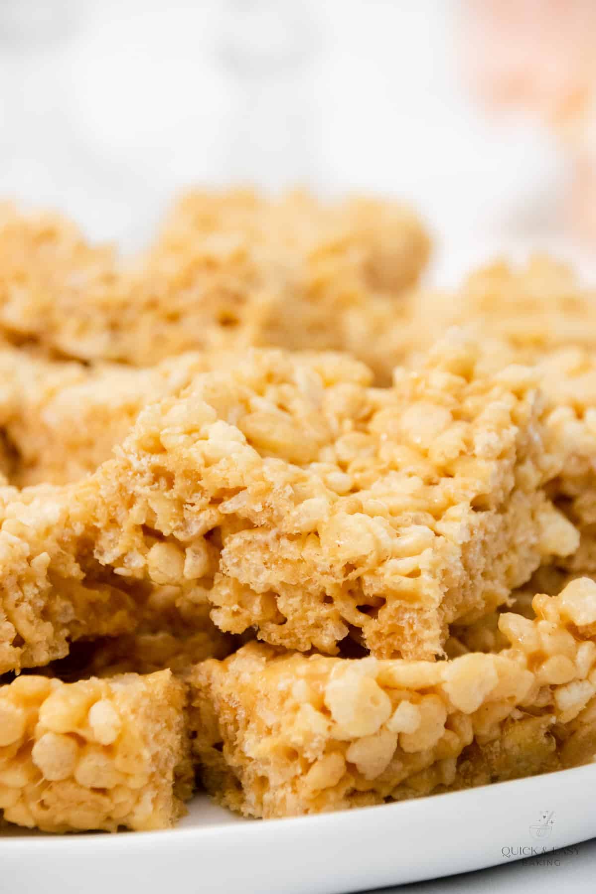 Close up of peanut butter rice krispie treats on a white plate.